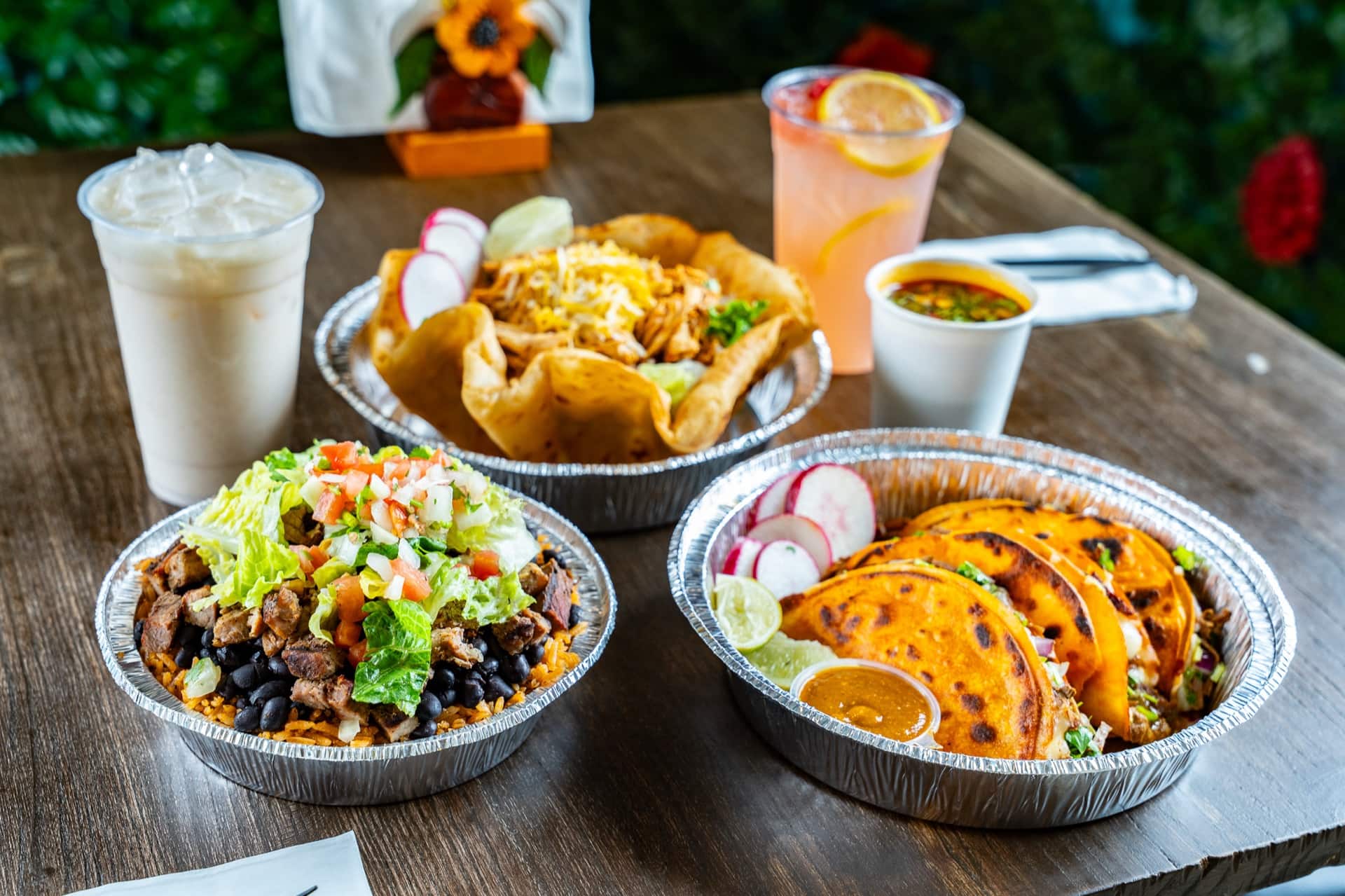 A full spread at Nino's Mexican Grill — vampiro tacos, taco salad bowl, burrito bowl, horchata and agua fresca